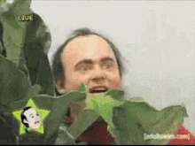 creepy-guy-behind-plant.gif