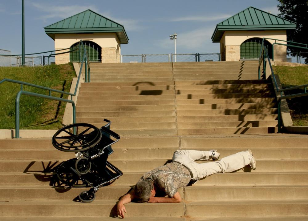 fallen-man-next-to-wheelchair-on-steps.jpg